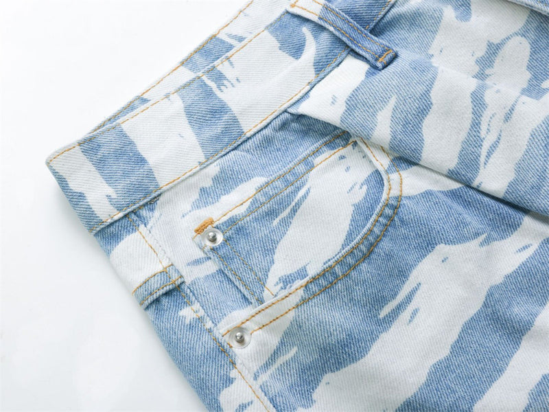 Close-up of back pocket and side seam on light blue zebra camo jeans
