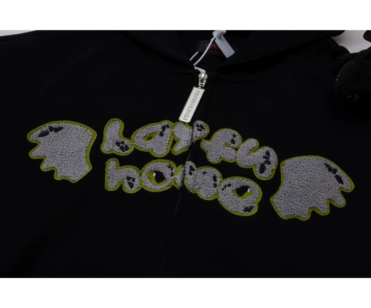 The Seakoff Cute Night Fury Dragon Hoodie is an anime-inspired full zip hoodie in black, featuring an embroidered &quot;lapful home&quot; text with green outlines and grey wing-like patches. Perfect for anime fans, this hoodie also includes 3D ears and a toy accessory.