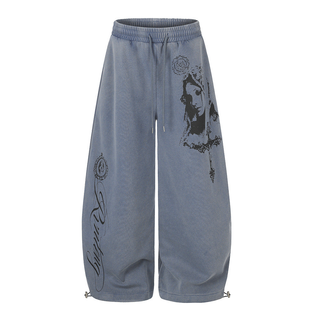 Men's acid-washed wide-leg sweatpants with Gothic Madonna and cross graphic print in washed blue