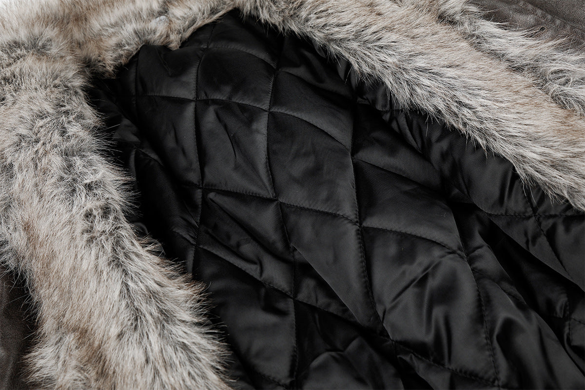 Close-up of black quilted jacket lining bordered by gray fur collar trim