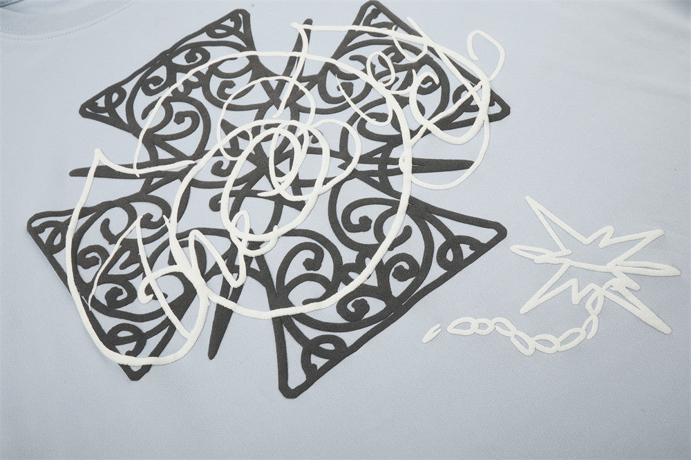 Close-up of Celtic cross graphic print on light blue long sleeve tee
