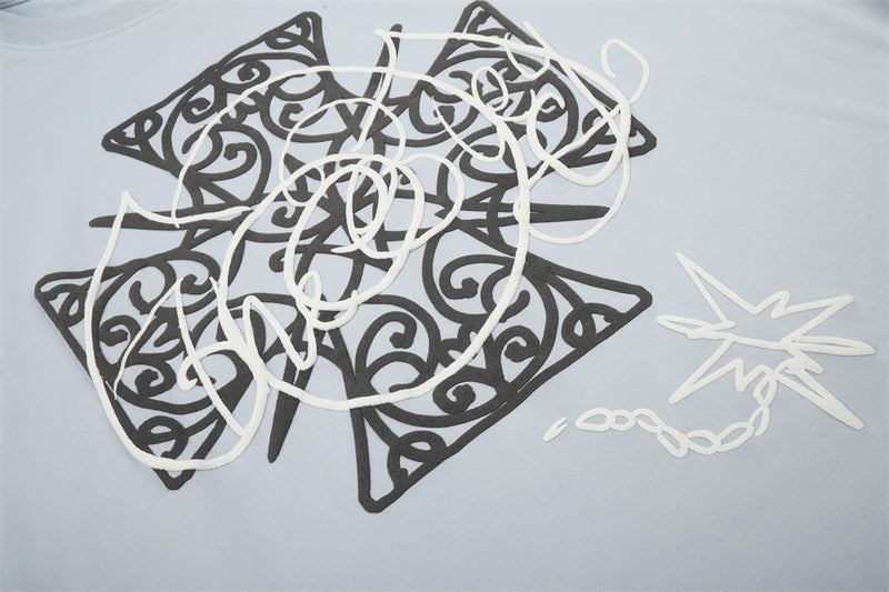 Close-up of Celtic cross graphic print on light blue long sleeve tee