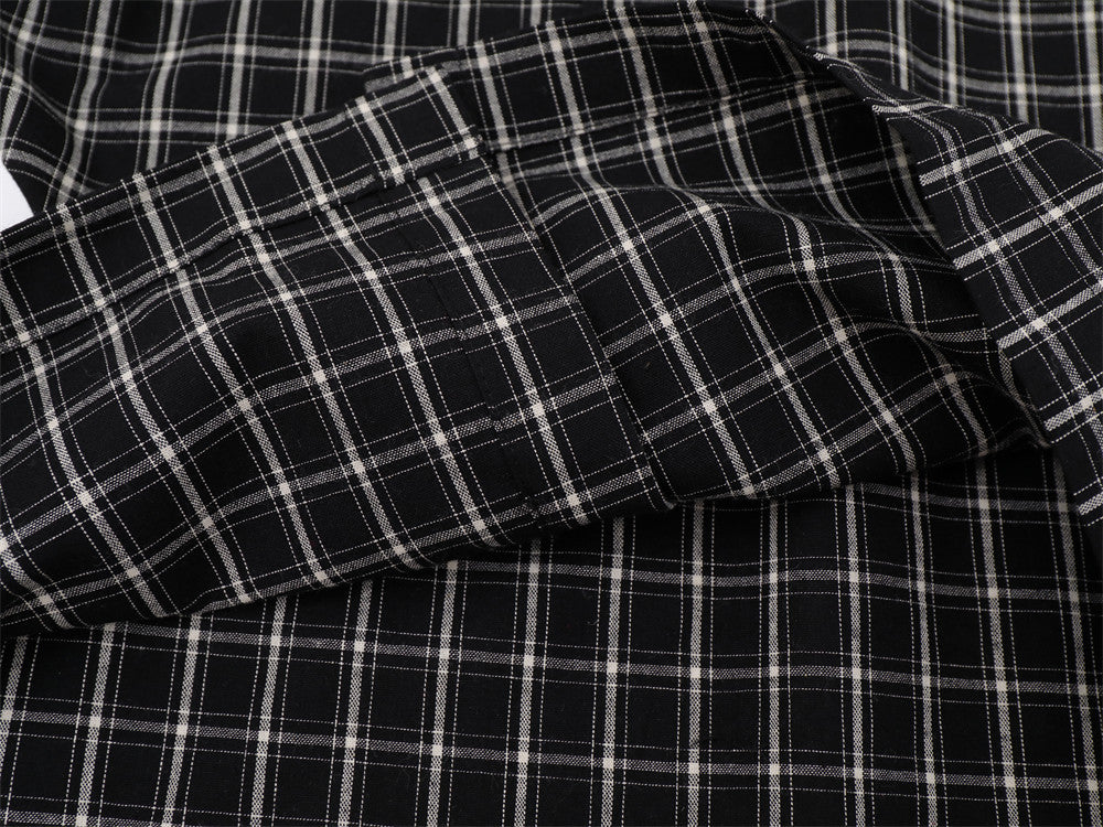Close-up of black plaid shirt sleeve and stitched cuff detail