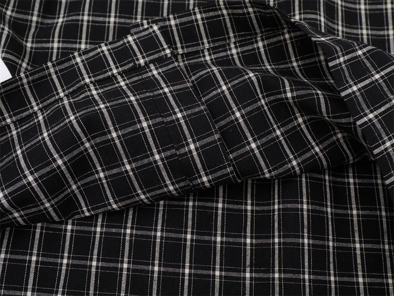 Close-up of black plaid shirt sleeve and stitched cuff detail
