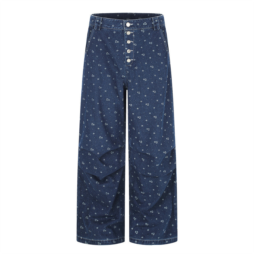 Front view of dark blue baggy jeans with floral print and five-button fly