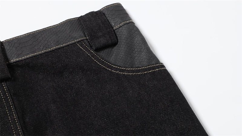 Close-up of the back waistband and belt loop on black denim jeans