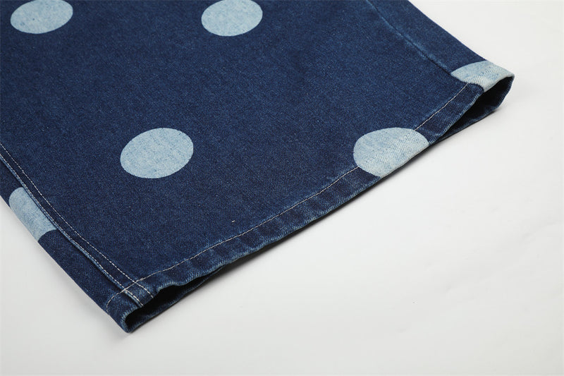 Close-up of hem on dark wash wide-leg jeans with light blue dots