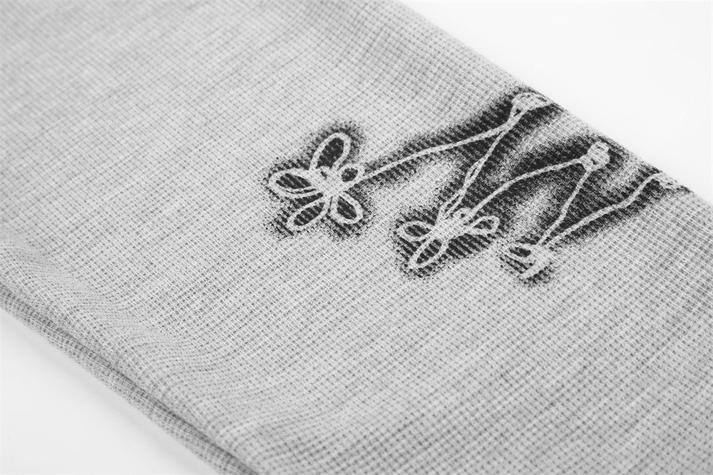 Close-up of gray tee sleeve hem with rope-knot lace-up graphic detail
