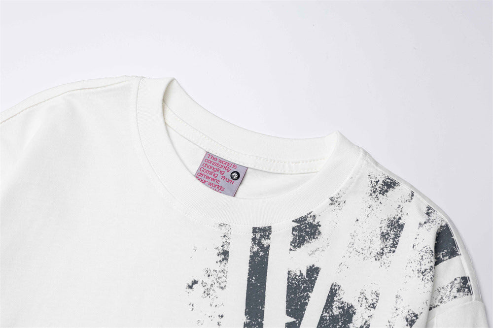 White crew neck tee collar and shoulder close-up with distressed black Union Jack print
