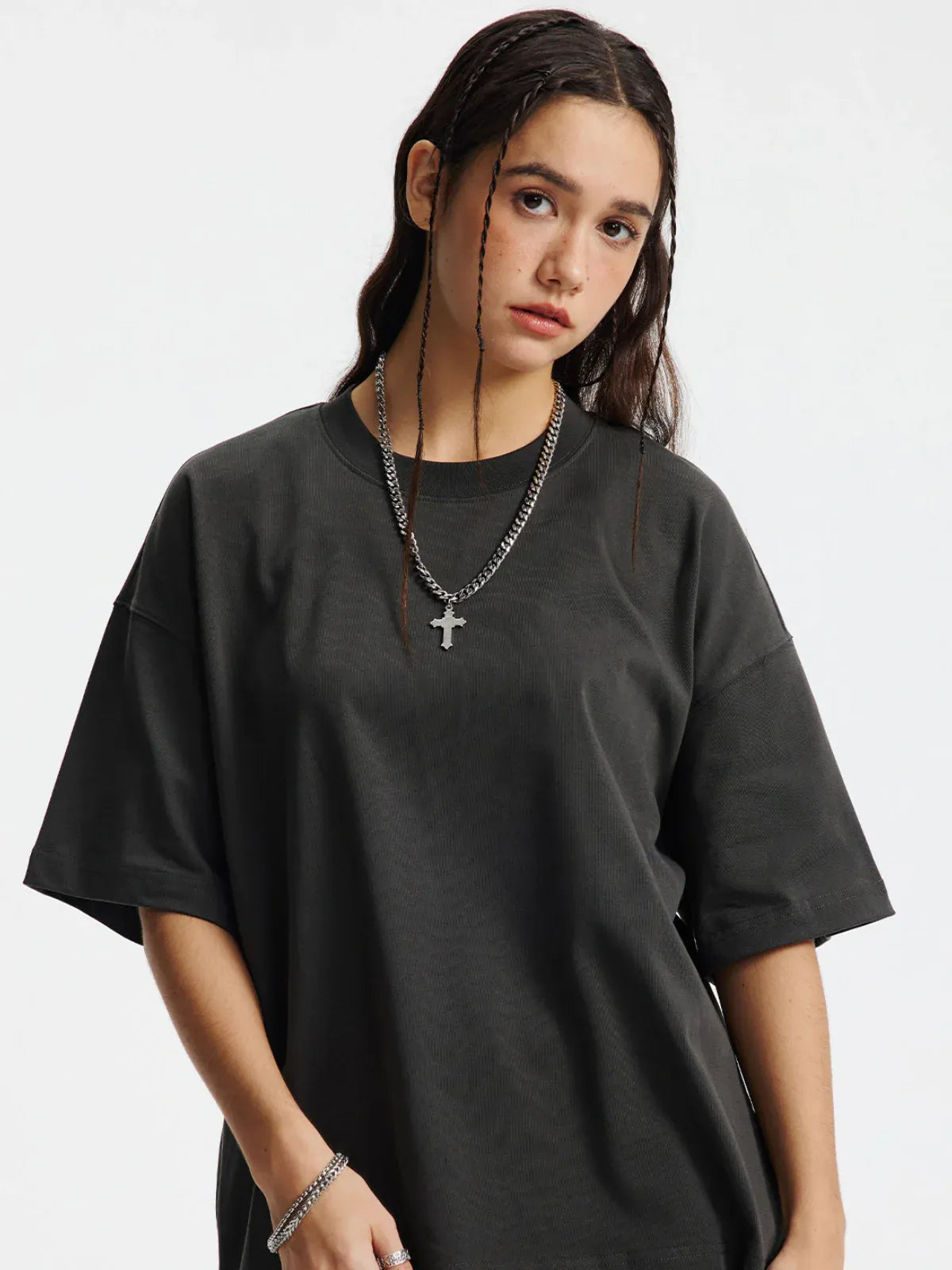 A young woman with long dark hair wears a Custom Anime Character Charcoal T-Shirt (230GSM 100% cotton) and a cross necklace, standing against a plain white background.