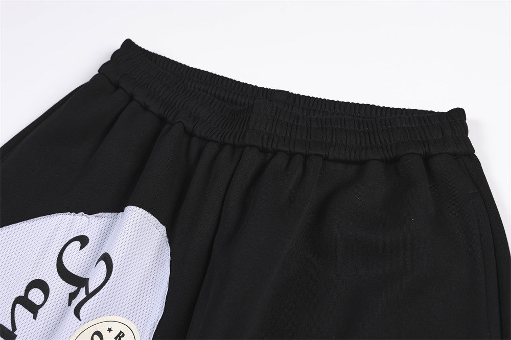 Wide-Leg Sweatpants with Camo & Script Patchwork Appliqués