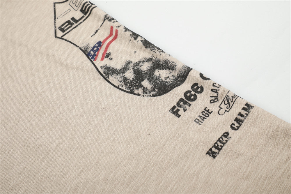 Diagonal close-up of beige tee graphic print with text along the side