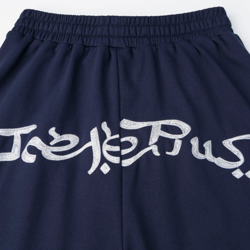 Pantalon de survêtement homme à jambes larges avec écusson brodé et imprimé graphique en écriture