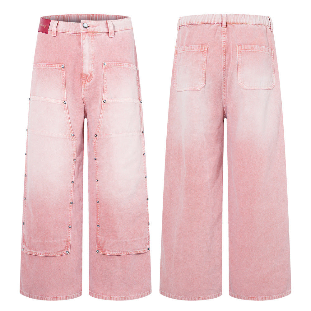 Pink washed wide-leg carpenter jeans with silver eyelet studded patchwork panels and oversized front pockets, front and back
