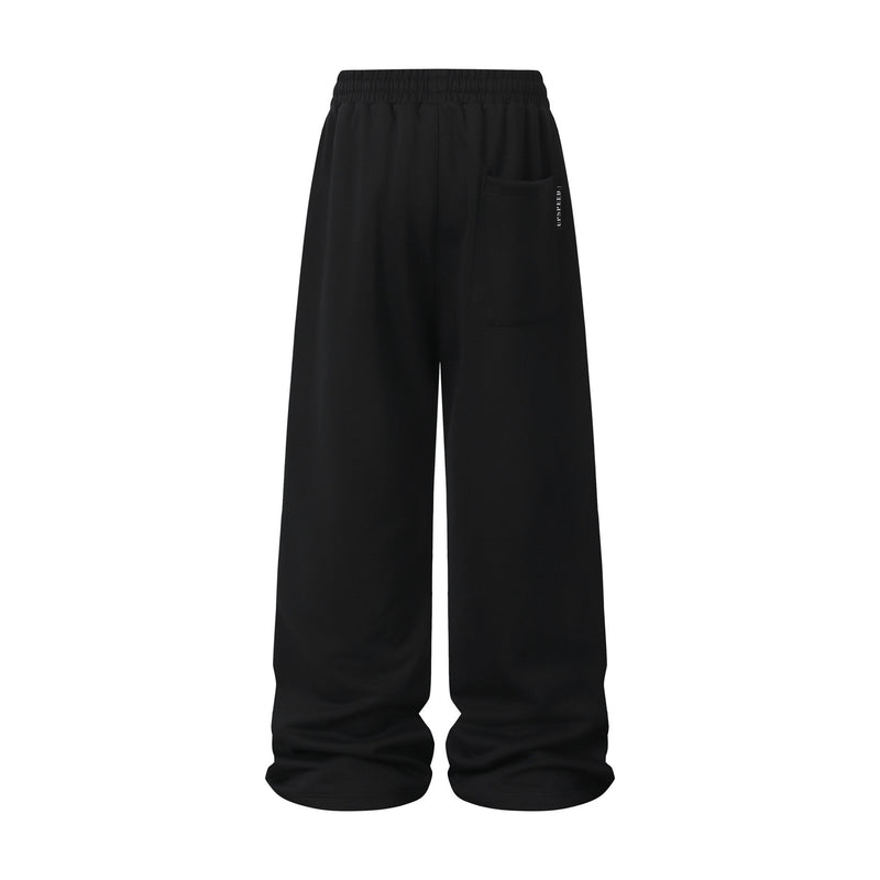 Pantalon de survêtement à jambes larges avec passepoil contrastant et écusson brodé