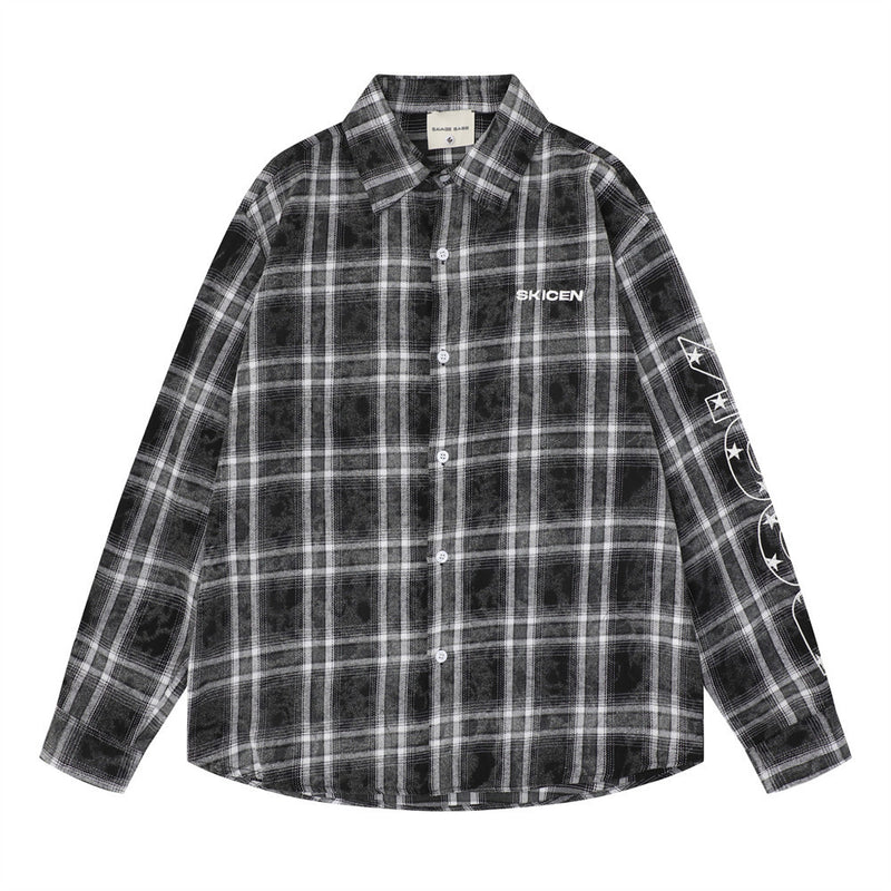 Front view of a black plaid long sleeve flannel shirt with white chest logo