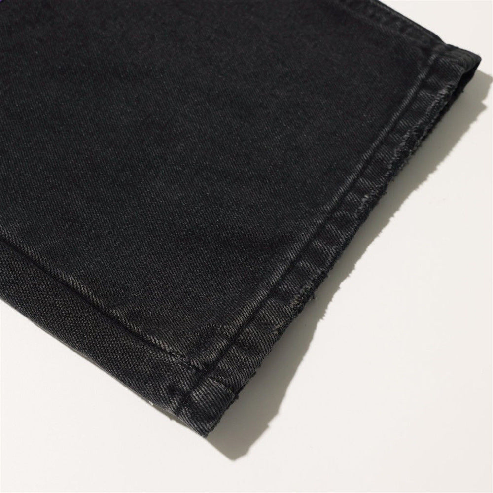 Close-up of black denim hem with stitched cuff