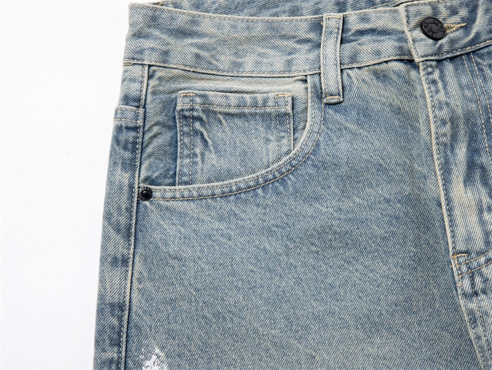 Close-up of front pocket and belt loop on faded blue jeans