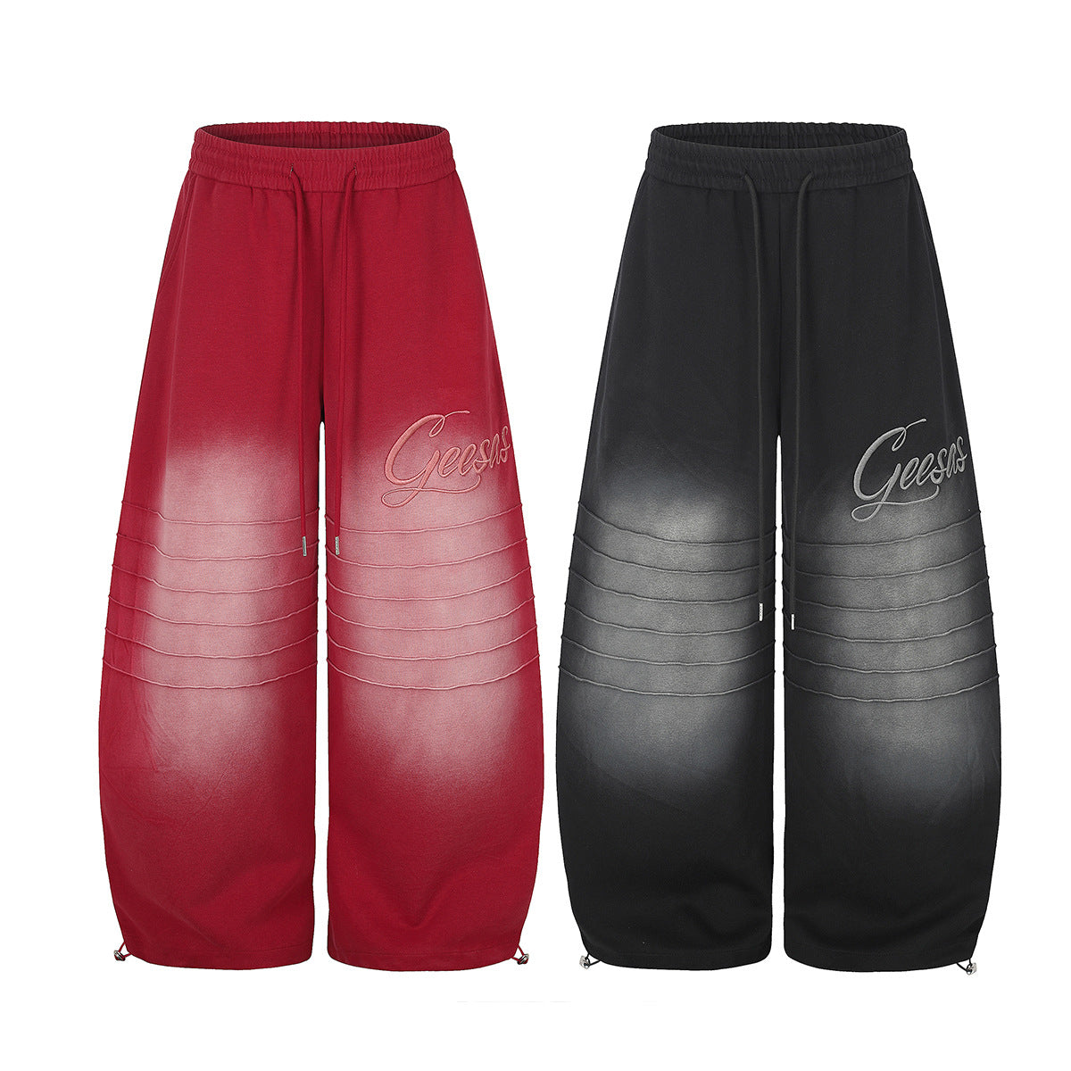 Pantalon de survêtement Geesas à jambes larges, dégradé délavé et détail de genoux plissés, en rouge et noir