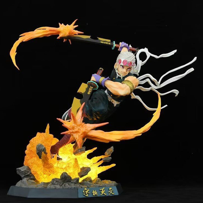 The Premium Demon Slayer Urogi Figure by Demon Slayer is a 37cm high-quality GK model. It features dynamic anime-style design with white hair, headband, two swords, and fiery orange USB light-up effects on rocky terrain with Japanese text on the base.