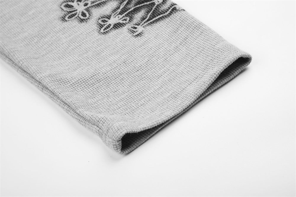 Close-up of gray tee sleeve cuff showing printed knot graphic near the hem