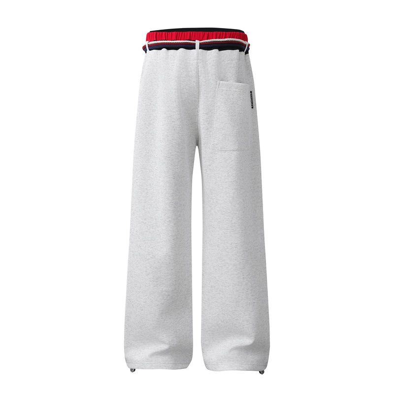Pantalon de survêtement à jambes larges avec double ceinture et cordon tressé