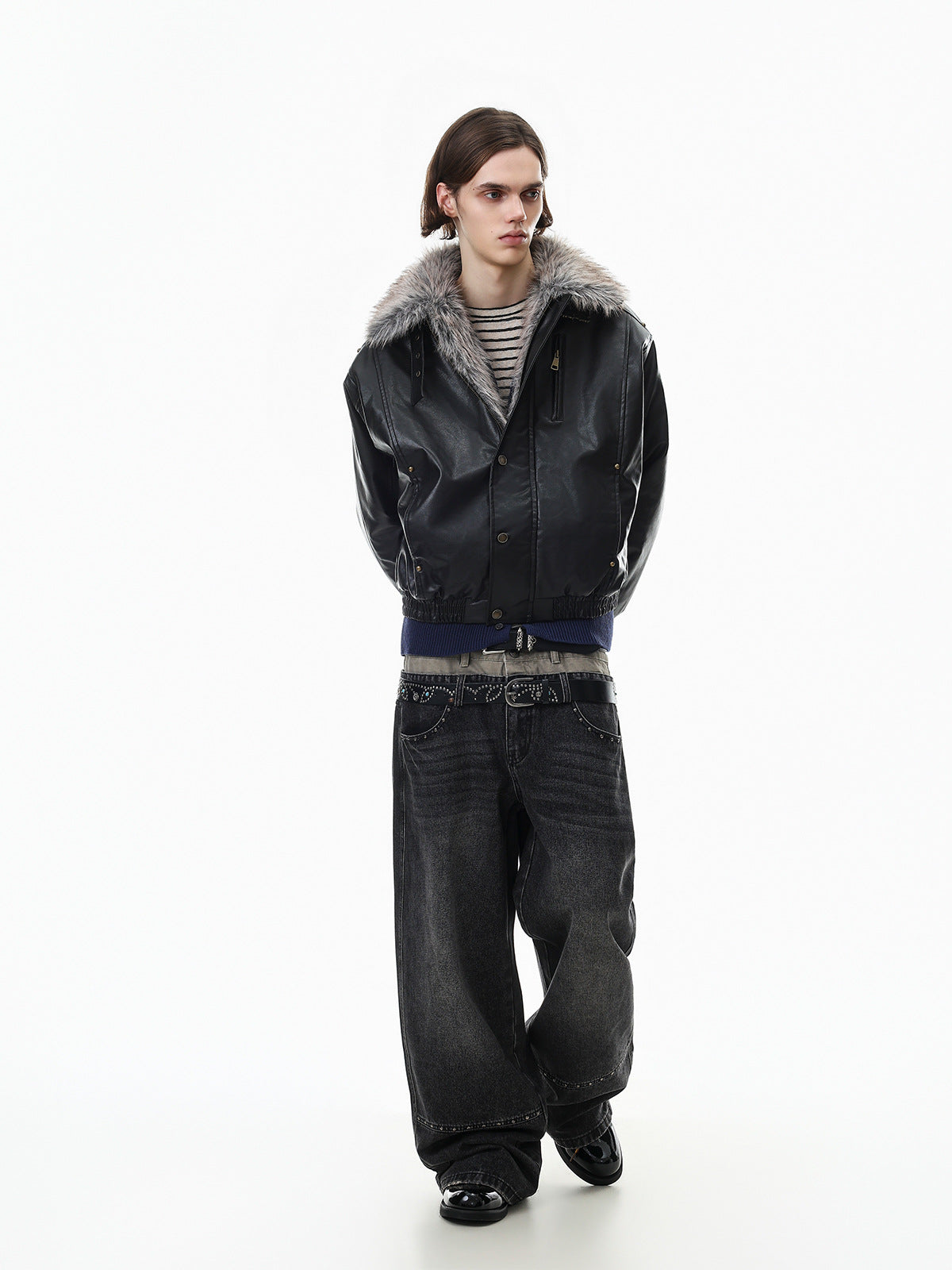 Full-body model wearing a black faux leather bomber jacket with gray fur collar