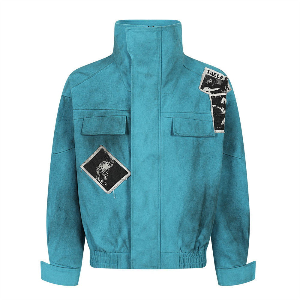 Distressed teal high-collar bomber jacket with graphic patches and cargo chest pockets, front view