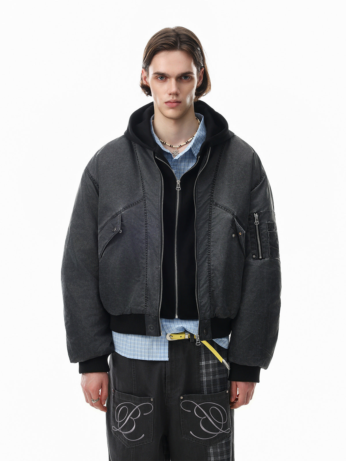 Oversized padded bomber jacket with faux two-piece hooded design in washed charcoal, worn with wide-leg cargo pants