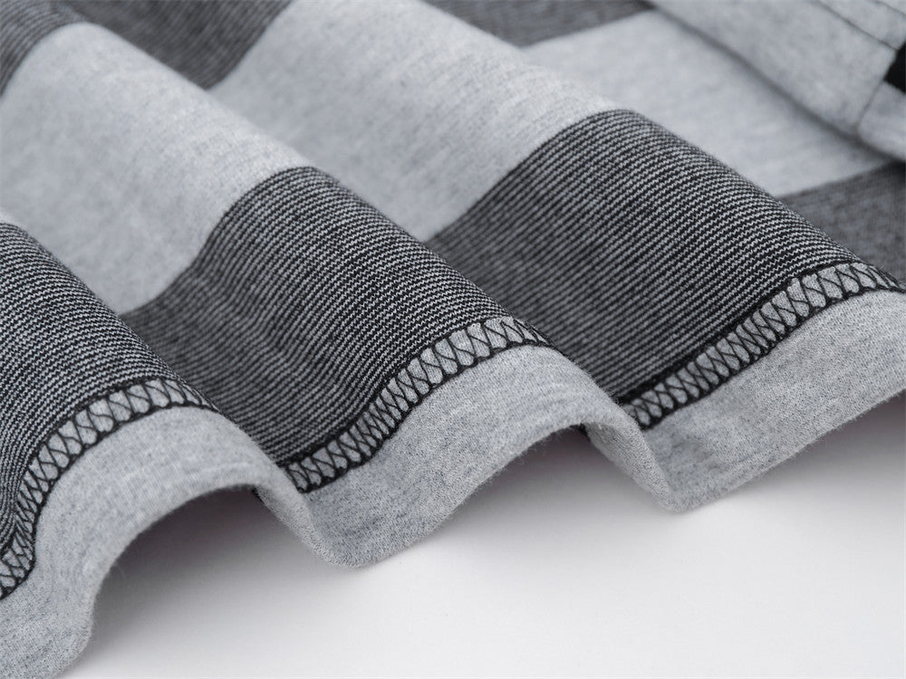 Close-up of hem stitching on black and gray striped shirt