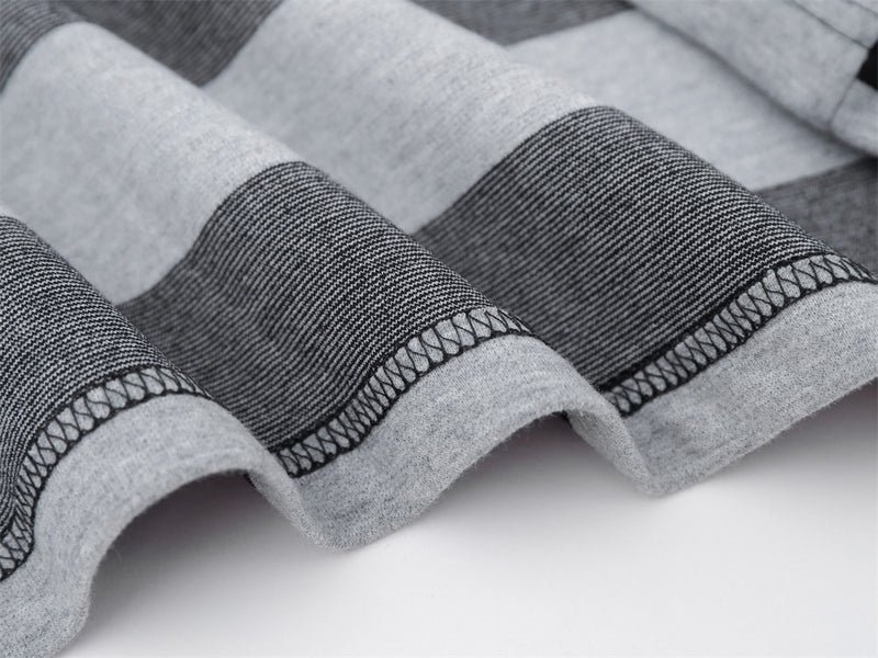 Close-up of hem stitching on black and gray striped shirt