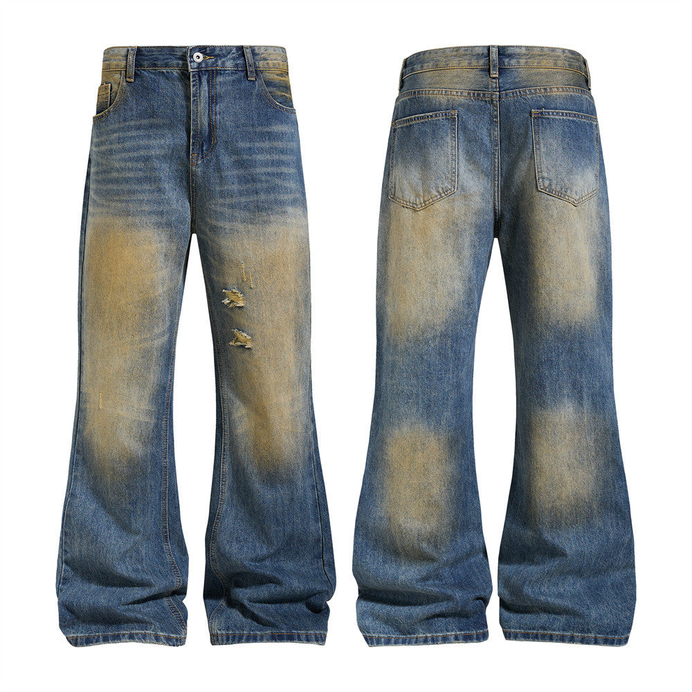 Men's distressed wide-leg flare jeans with vintage mud-dye yellow-ochre fading and ripped knee detail, front and back view