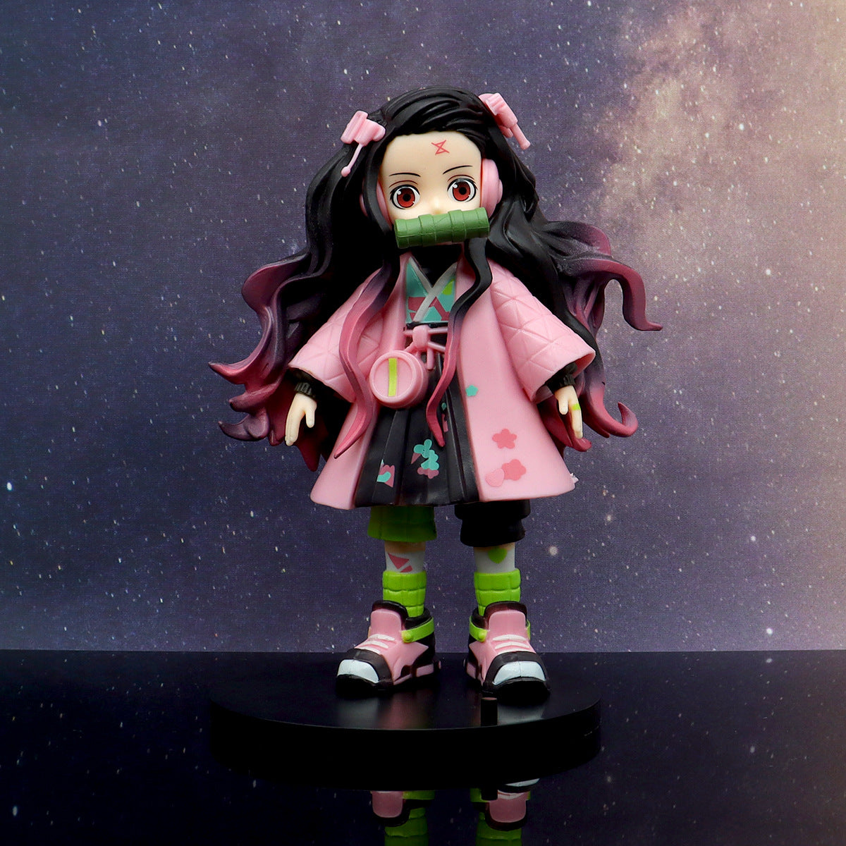 This 17cm high-quality PVC figure from the Demon Slayer brand portrays Nezuko with black and pink hair, a pink kimono, and green leggings. She stands on a black base with a rectangular piece in her mouth, making it an ideal anime gift.