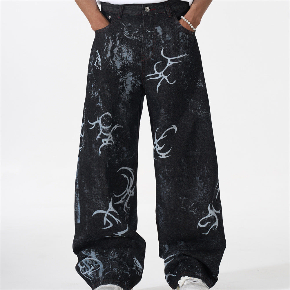 Black distressed wide-leg baggy jeans with all-over white tribal graphic print, front and back view