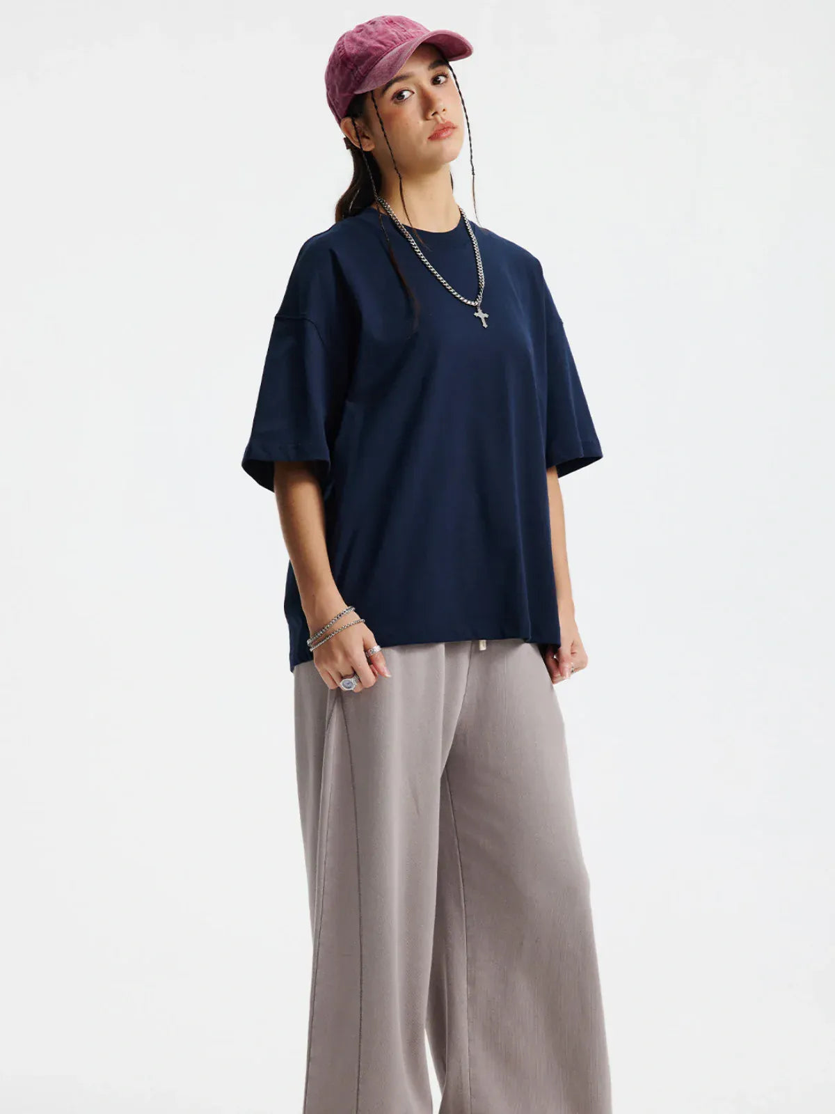 A person in a pink cap, beige wide-leg pants, jewelry, and a Custom Anime Character Navy T-Shirt - Personalized 230GSM 100% Cotton Tee stands against a plain light background.