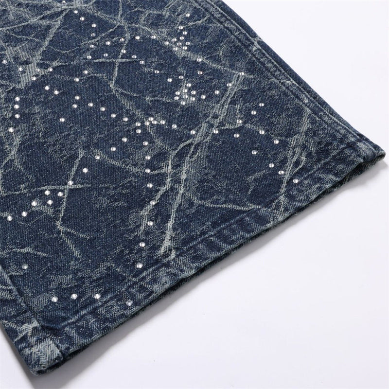 Close-up of jean hem showing faded wash and rhinestone constellation pattern