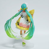 The Fairy Tale Sleeping Beauty Hatsune Miku 19cm PVC Figure showcases teal hair and a vibrant outfit, perfect for Vocaloid enthusiasts. Holding a yellow pillow and wearing a rose-adorned dress, she elegantly stands on a round white base, embodying Sleeping Beauty charm.