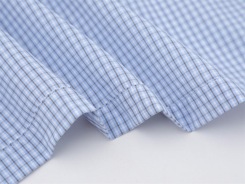 Close-up of the light blue plaid shirt straight hem with side seams