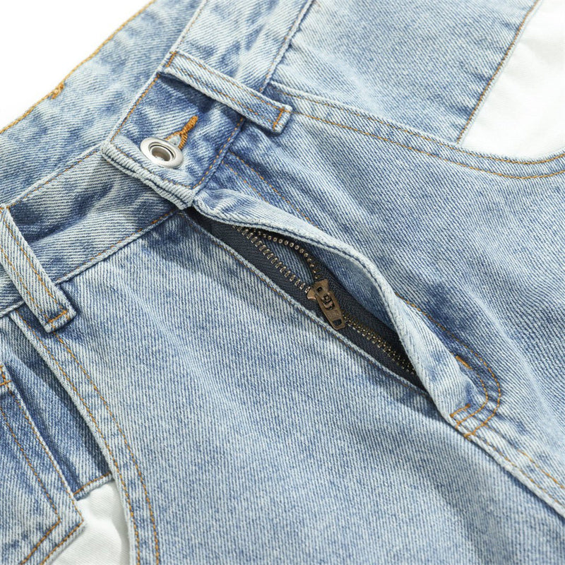 Close-up of front pocket showing zipper opening in light wash jeans