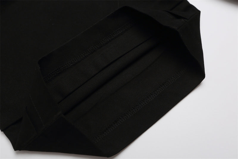 Close-up of black shorts back hem with stitched cuff detail