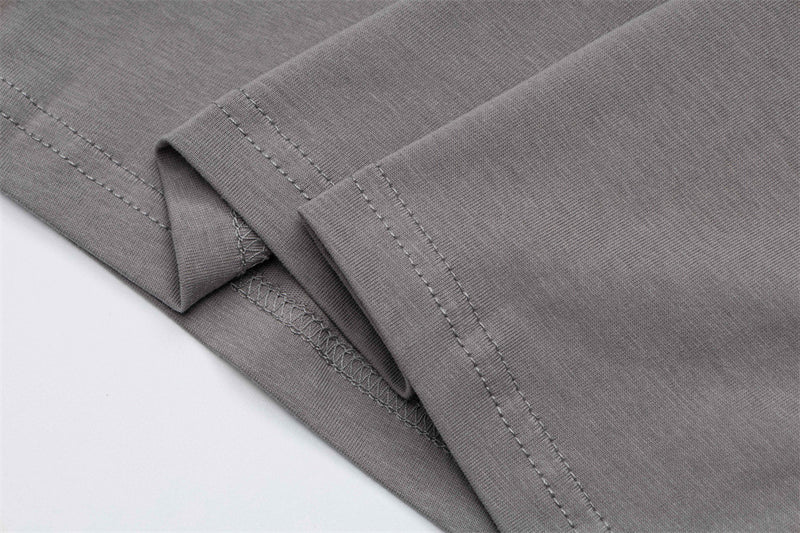 Close-up of gray T-shirt sleeve cuffs with stitched hems