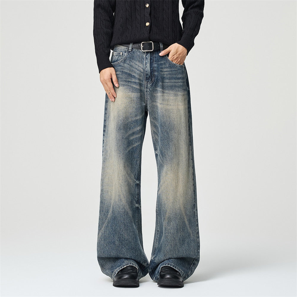 Men's wide-leg baggy jeans in vintage washed blue denim, front and back view showing sand-wash fading and whisker distressing