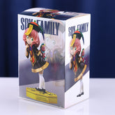 Box contains an 18 cm PVC figure model of Anya Forger in a school uniform with a toy, by Spy × Family. Features pink hair, a black dress with gold accents, white socks. The packaging showcases various images of the figure and prominently features the "Spy x Family.