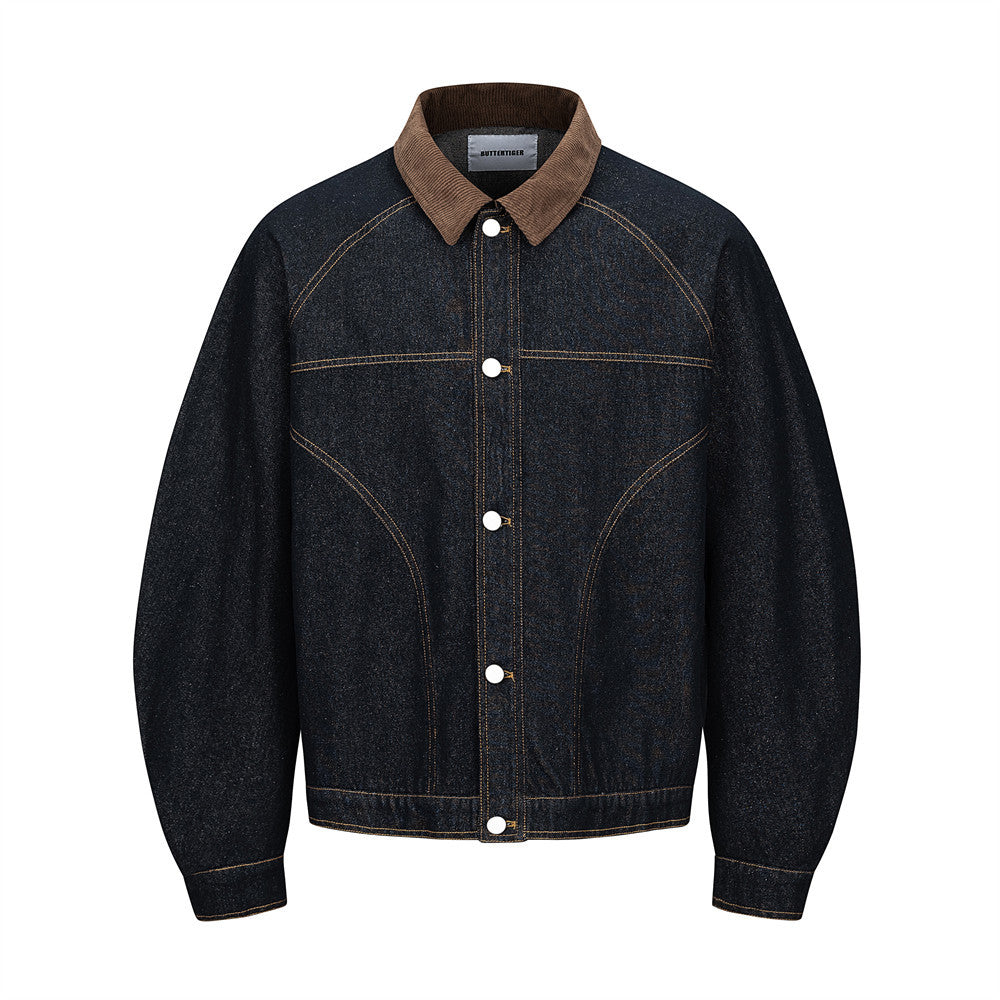 Men's raw indigo denim jacket with brown corduroy collar and deconstructed curved seam paneling, front view