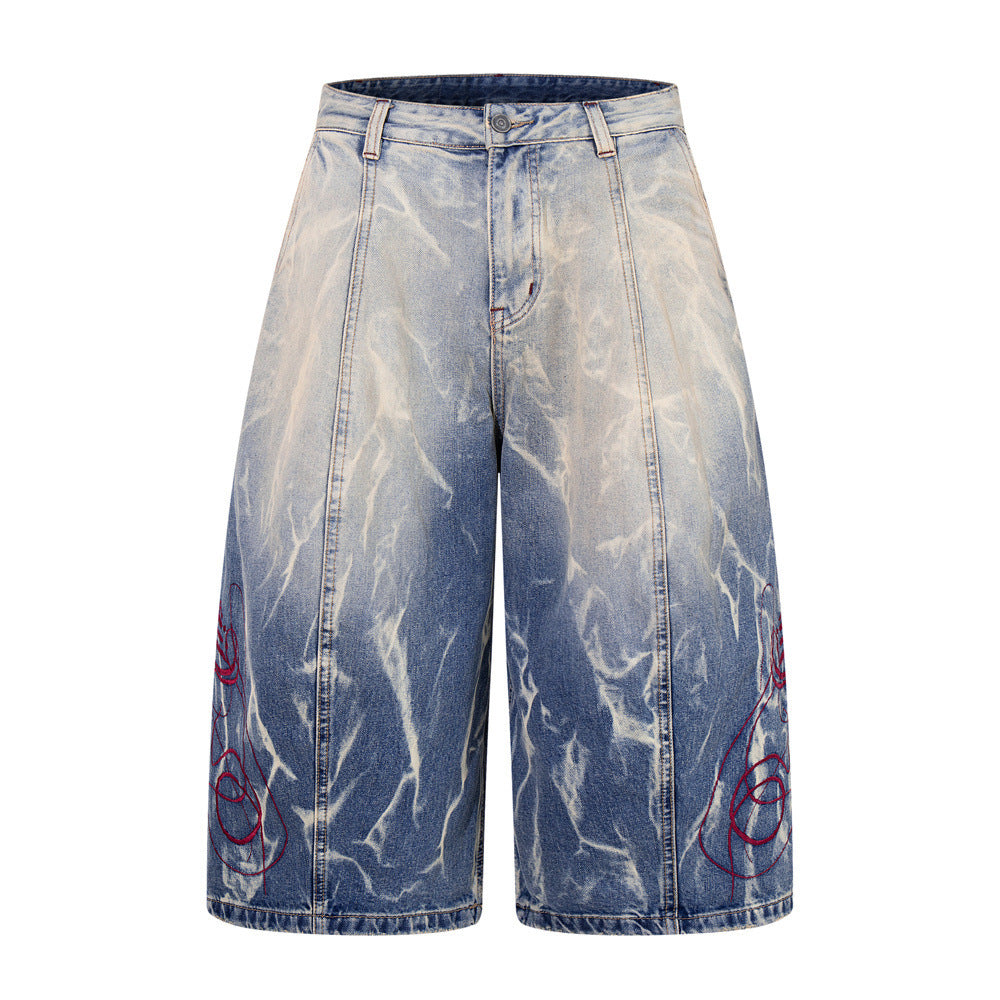 Wide-leg tie-dye washed denim shorts with red embroidery on lower legs, front and back view