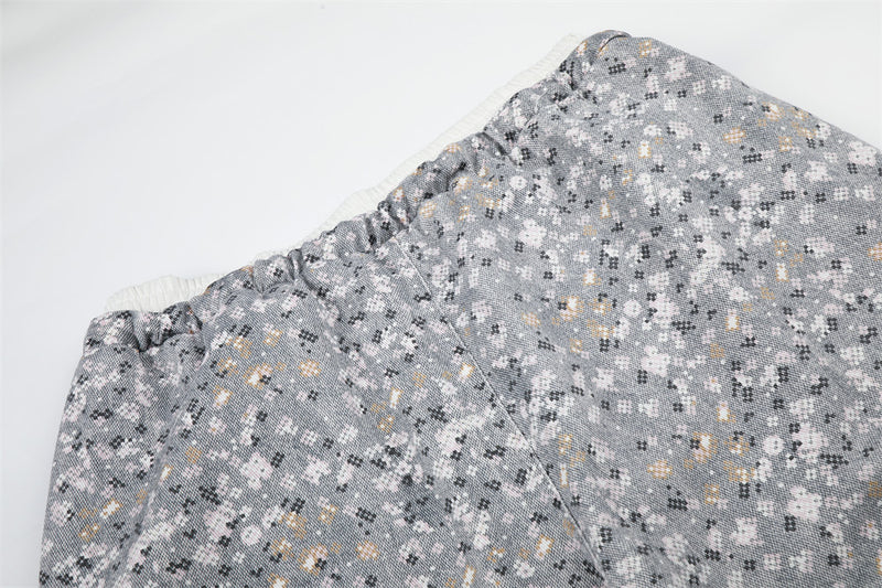 Close-up of upper pants leg with elastic waistband and floral print fabric