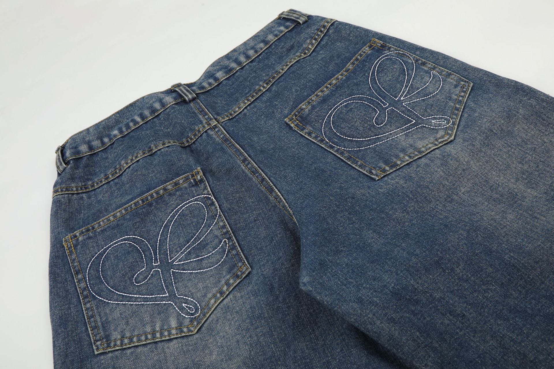 Baggy-Jeans mit weitem Bein, Pelzbesatz am Saum und goldfarbenen Nieten