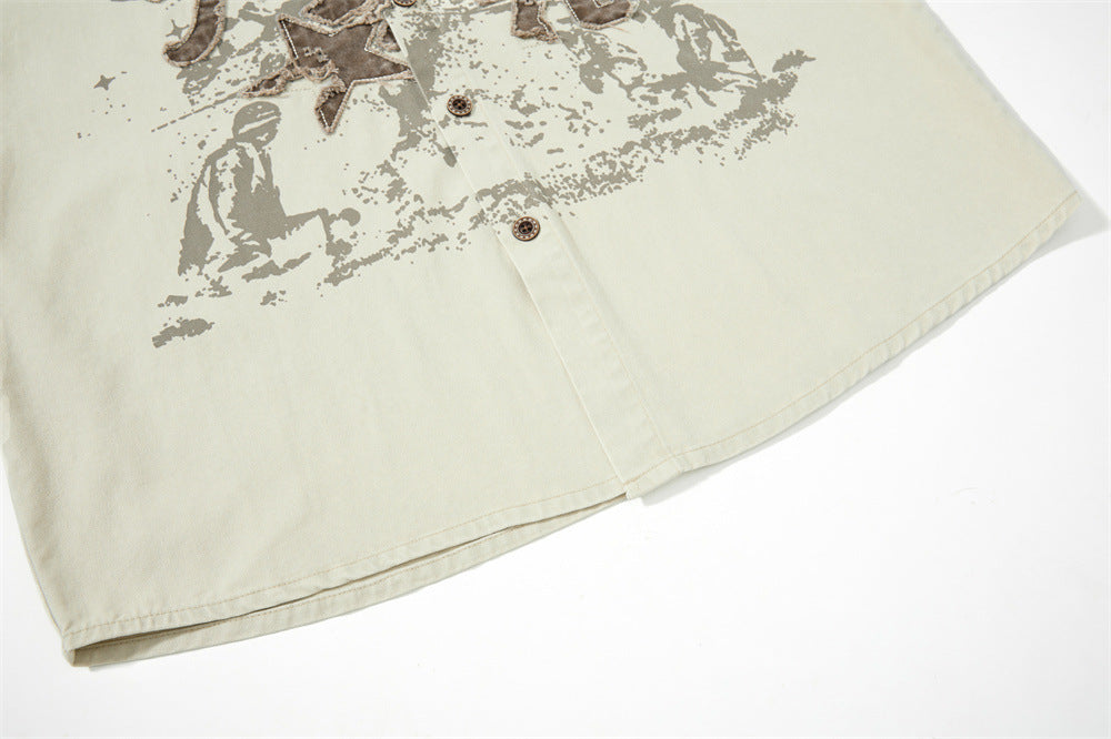 Lower front hem of cream button-up shirt with faded graphic print
