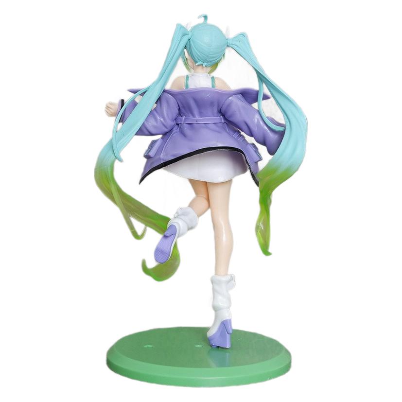 The Hatsune Miku Waist Bag Cheerleader with Cat Ears 21.5cm PVC Figure showcases long teal hair, cat ears, a purple jacket, and white skirt. Standing on one leg atop a green base, her dynamic pose exudes cheerleader vibes as she extends her arms energetically from the rear.