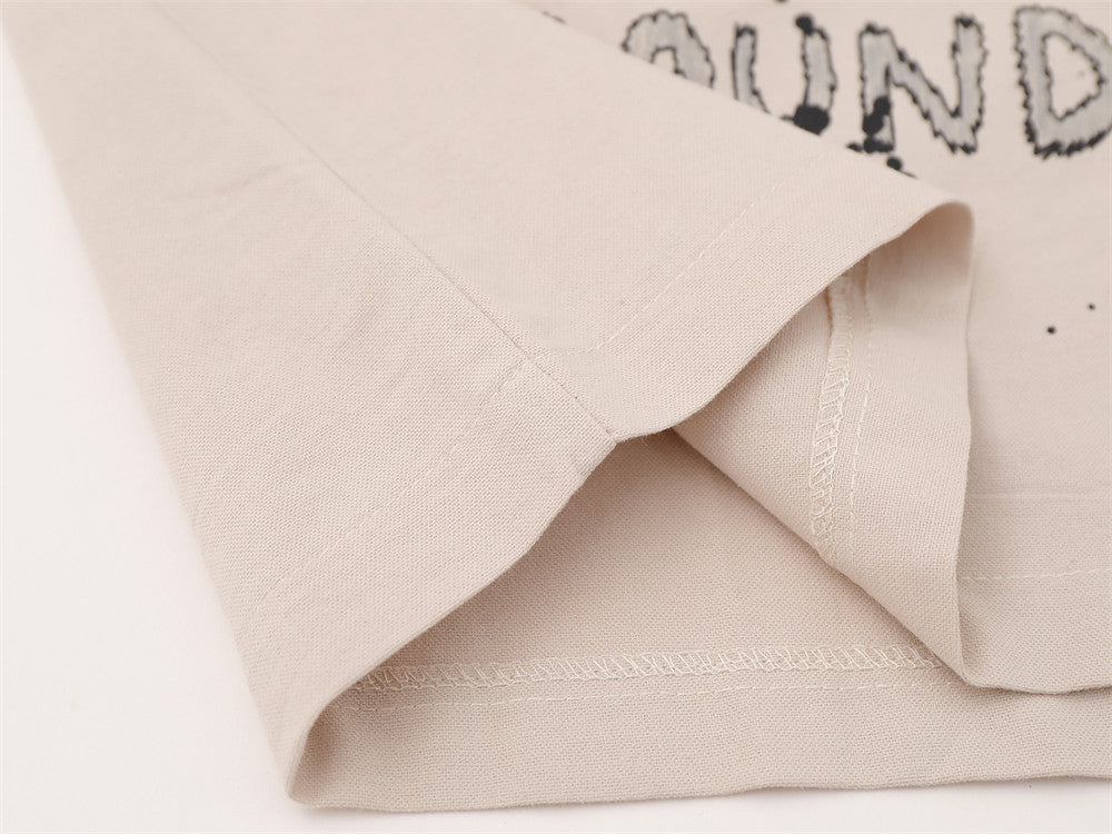 Close-up of beige shirt hem with stitched edge detail
